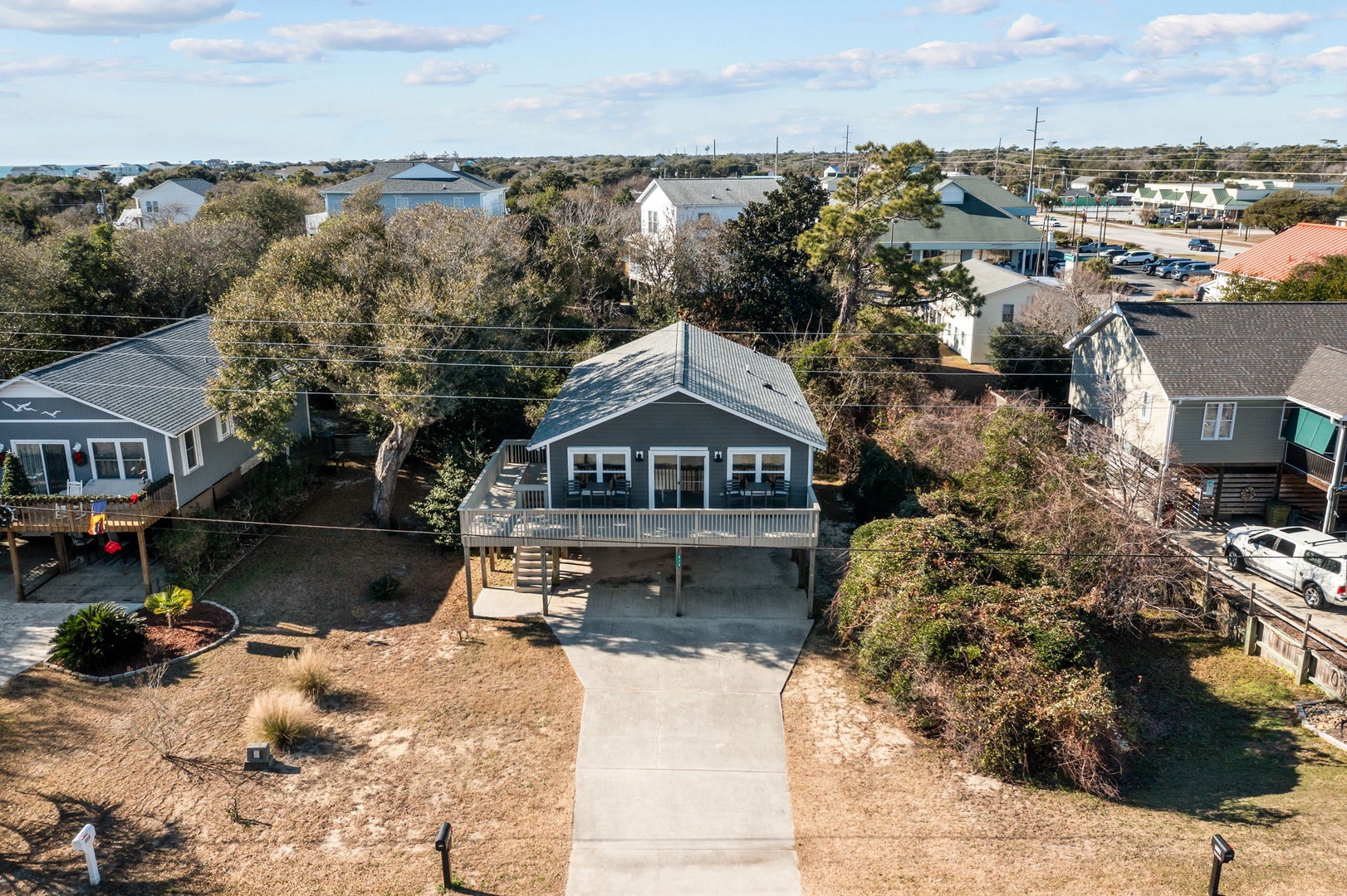 Coastal property nestled in a charming residential neighborhood with mature trees and easy parking access.