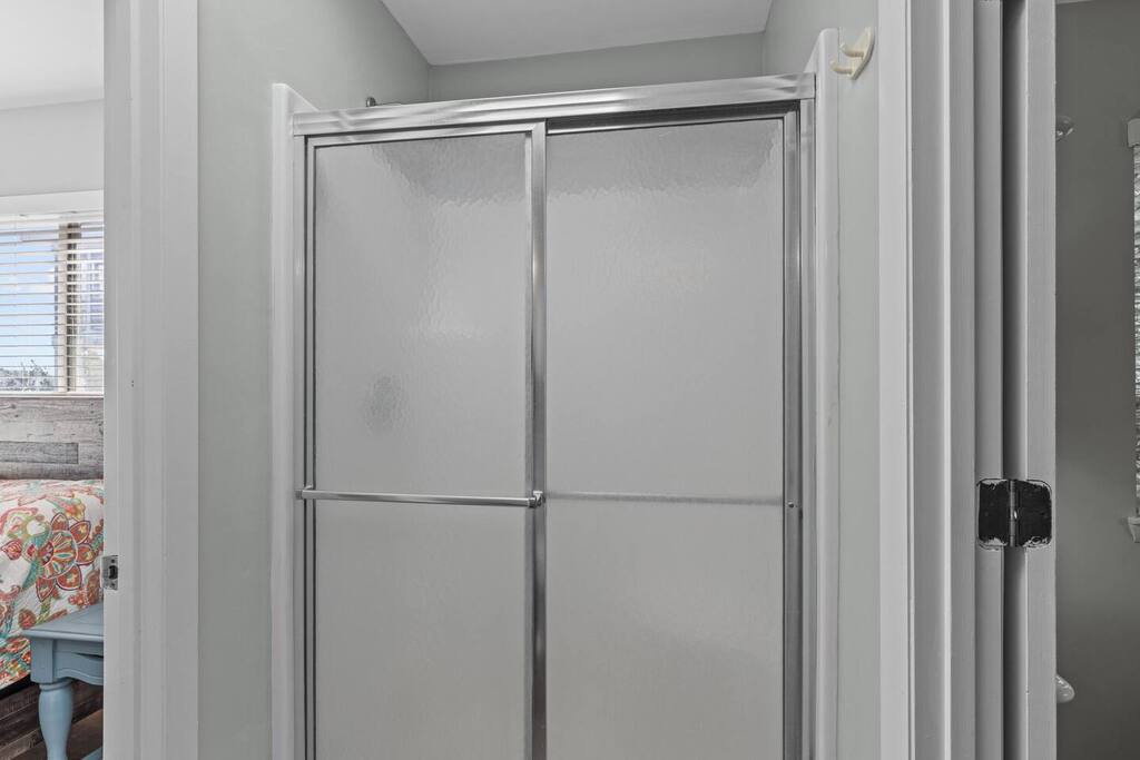 Step into your spacious glass-enclosed shower featuring sliding doors and modern fixtures, perfectly designed for refreshing starts to your day.