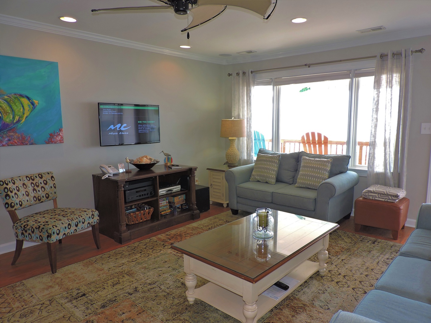 Relax in your bright living room with comfortable seating, entertainment center, and tropical touches that make you feel at home.