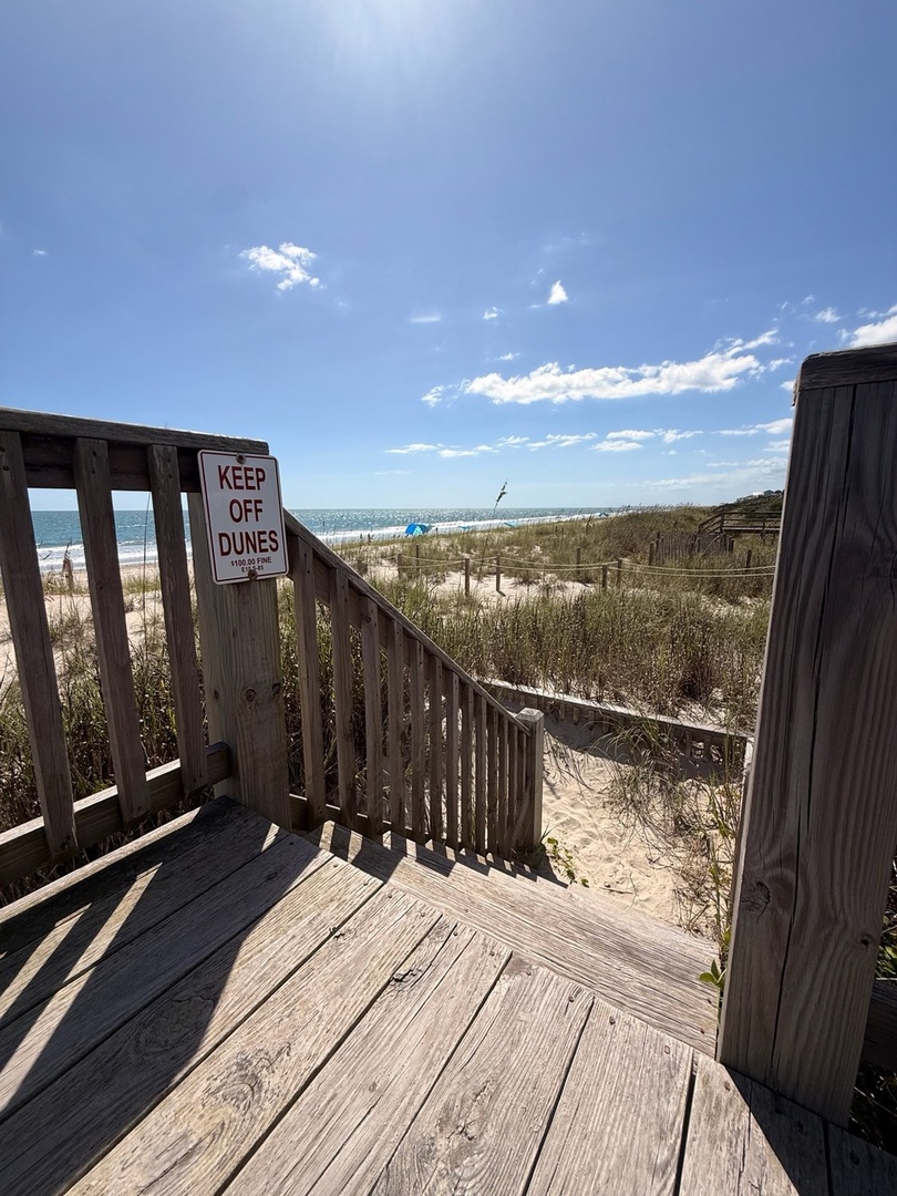 A private boardwalk leads you directly to pristine white-sand beaches and gentle ocean waves—your perfect coastal escape awaits.