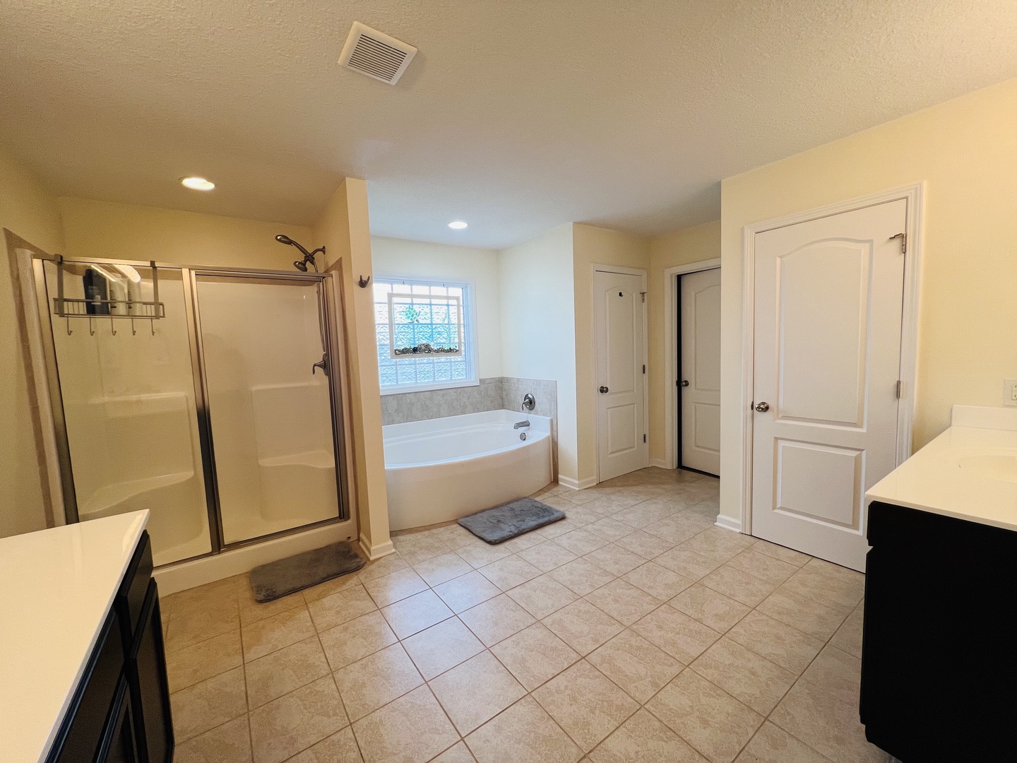 Unwind in your spacious master bathroom featuring a soaking tub and walk-in shower, perfect for relaxing after your adventures.