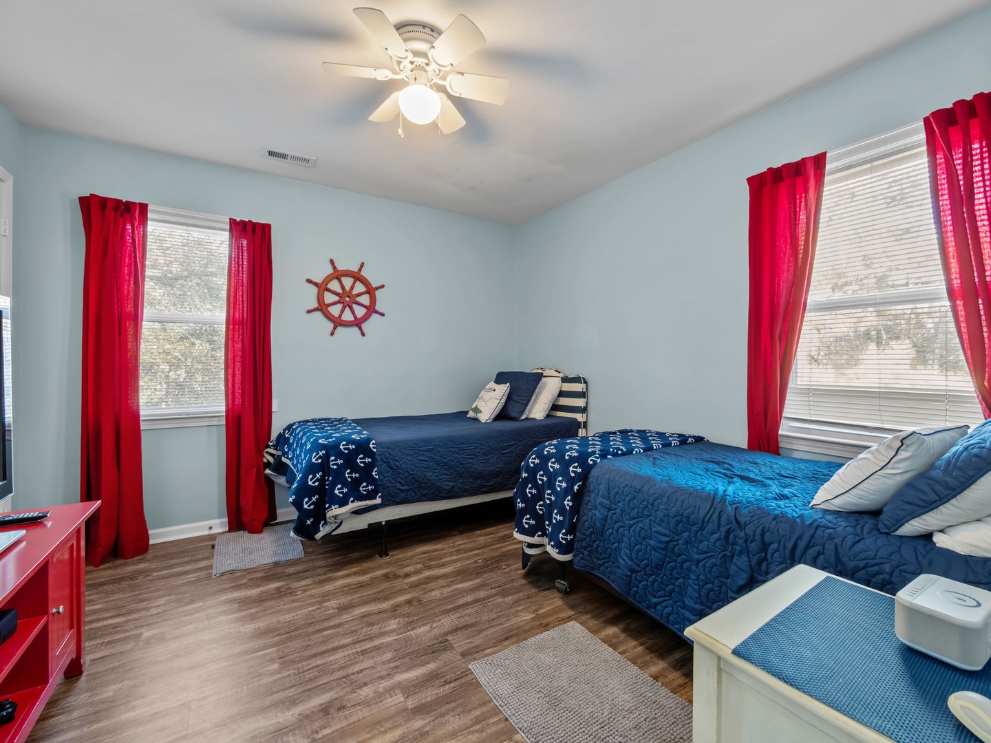 Sleep soundly in this nautical-themed bedroom with twin beds, perfect for kids or friends sharing the coastal adventure.