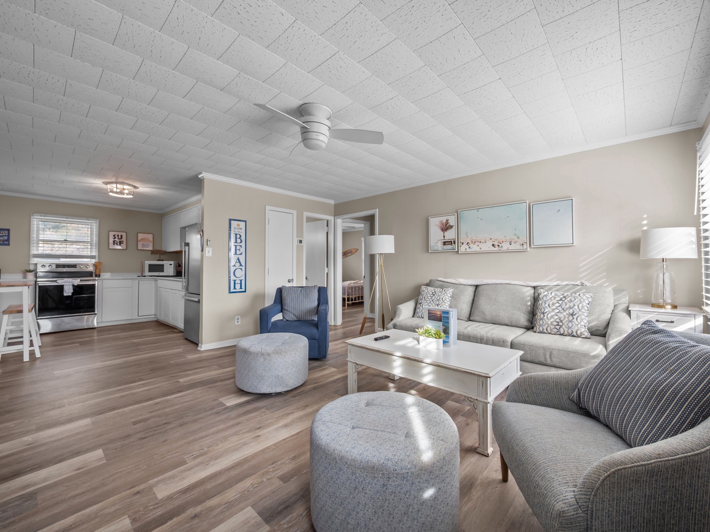 Relax in your spacious living area with comfy seating and coastal decor, perfect for unwinding after beach days.