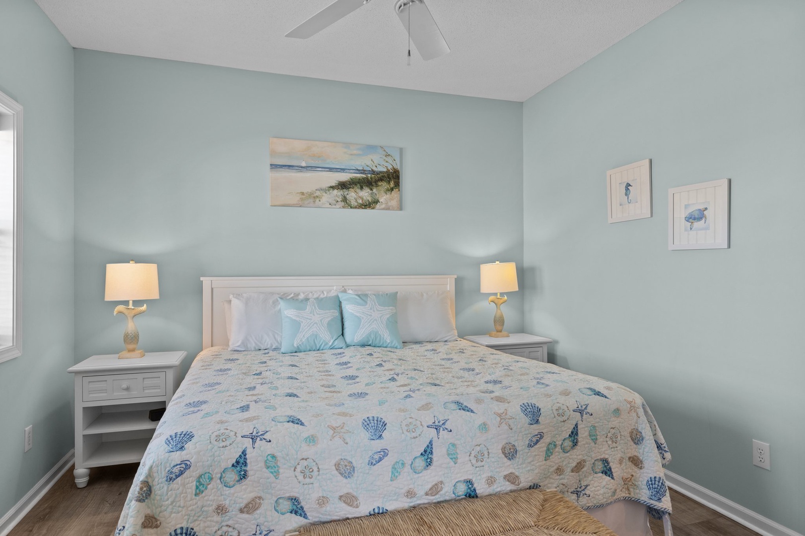 Drift off to sleep in this serene coastal bedroom with soft aqua walls and charming seashell bedding that whispers of ocean dreams.