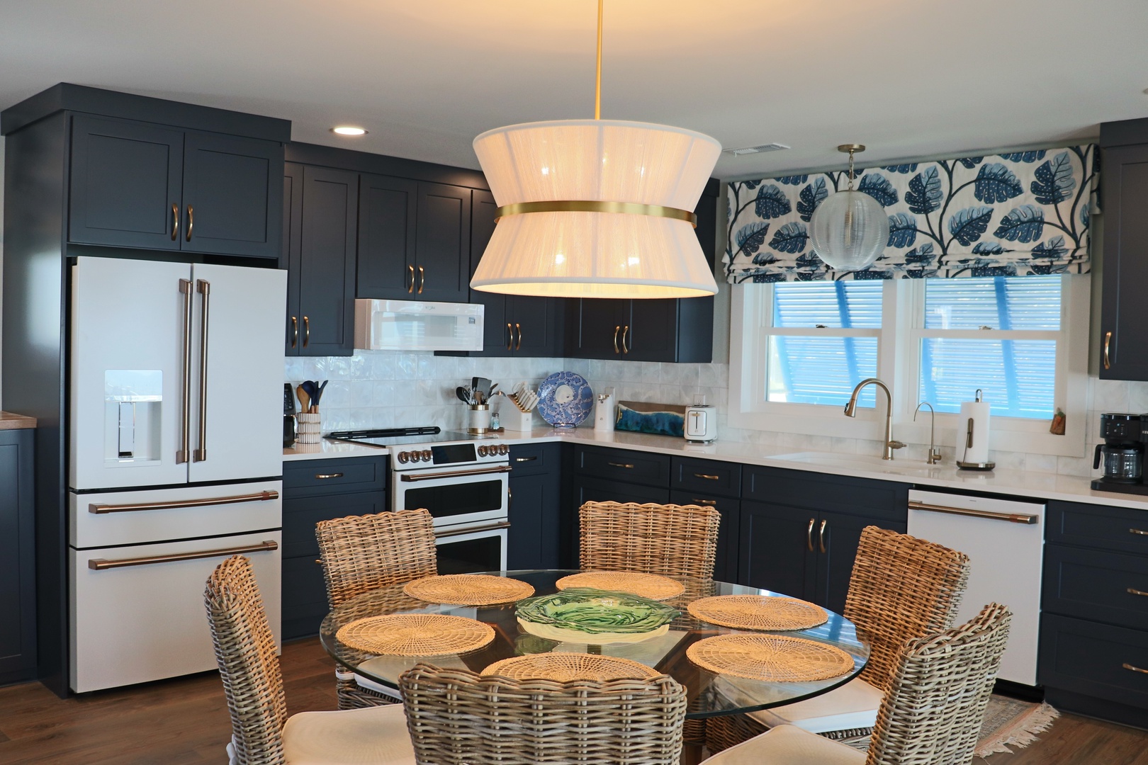 Your stylish kitchen awaits with sleek navy cabinets, gleaming appliances, and a cozy dining nook where you'll savor morning coffee and plan adventures.