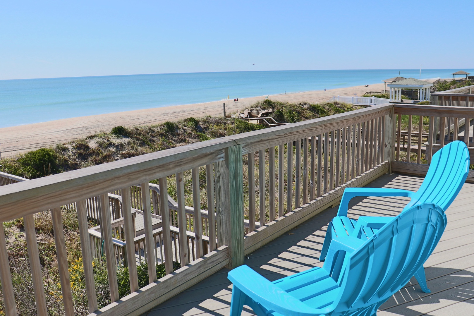 Settle into these turquoise chairs on your private deck and soak in stunning ocean views stretching to the horizon.