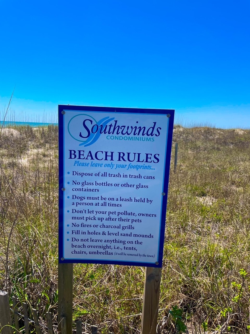 Southwinds Condominiums beach rules sign marking the path to pristine coastal access and sandy shores.