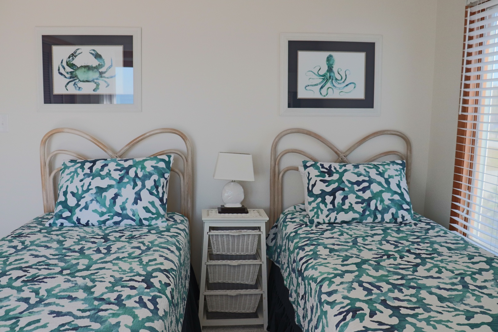 Drift off in this coastal-themed twin bedroom where ocean-inspired artwork and coral pattern bedding create your perfect seaside retreat.