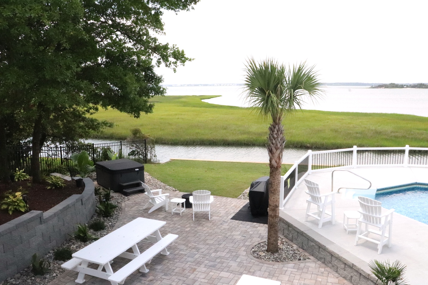 Relax by your private pool while soaking in stunning waterfront views. The spacious patio offers multiple seating areas perfect for outdoor dining and unwinding.