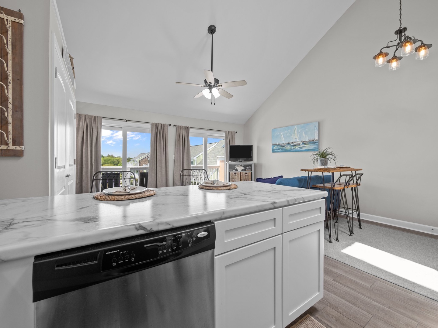 You'll love preparing meals in this bright, modern kitchen featuring marble countertops, a convenient island, and stylish dining space.