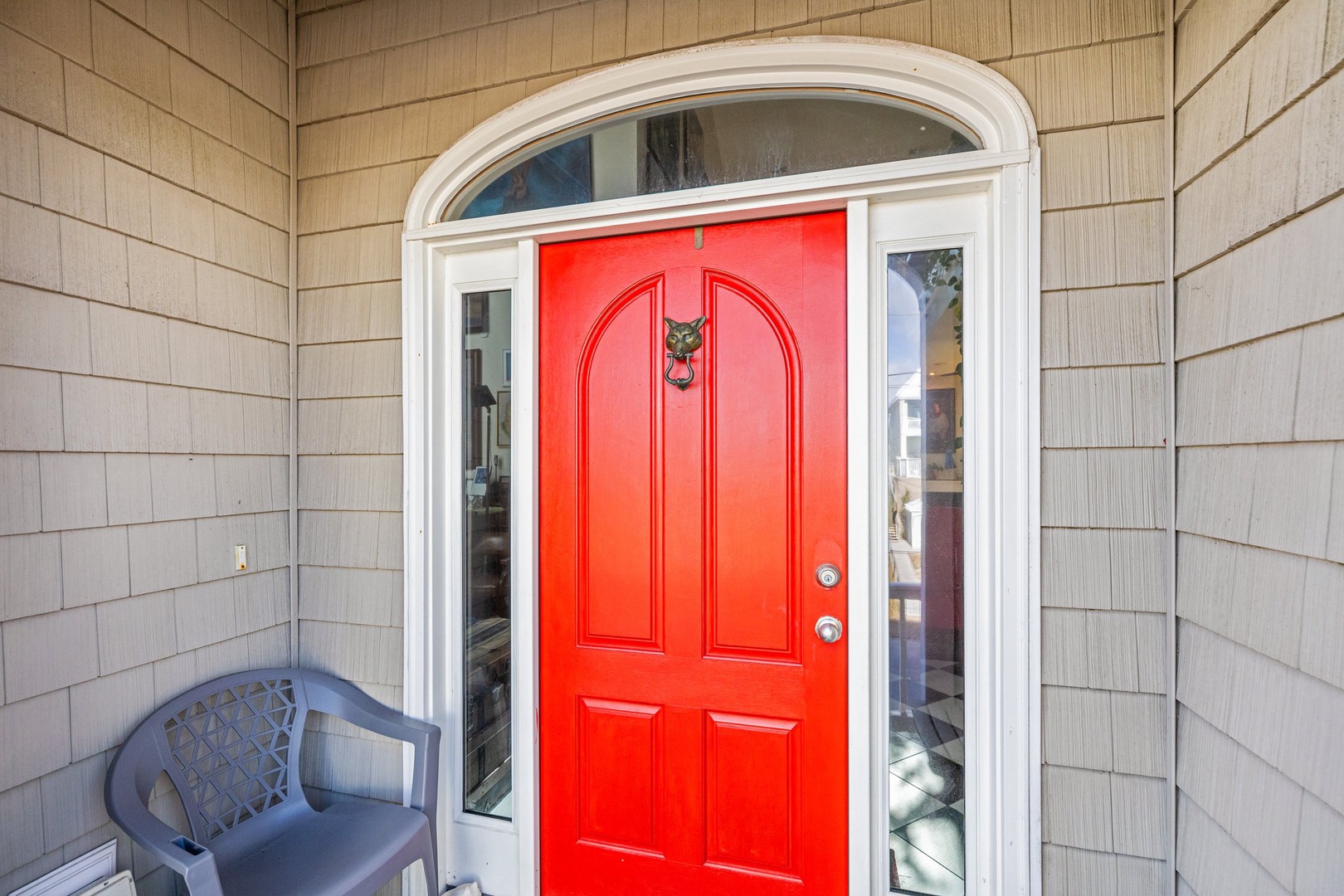 Step through your welcoming red door into a charming retreat where coastal comfort awaits.