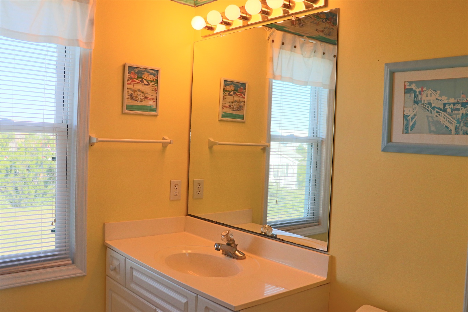 Bright vanity area with Hollywood-style lighting creates your perfect morning routine space, complete with ample counter space and natural light.