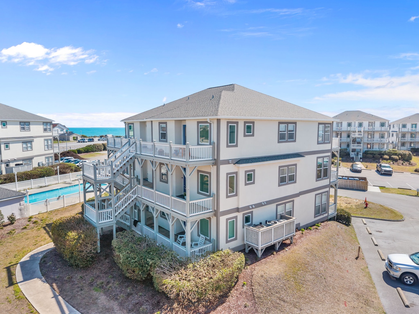 Coastal vacation home with ocean views and multiple decks in a beachside community near pristine turquoise waters.