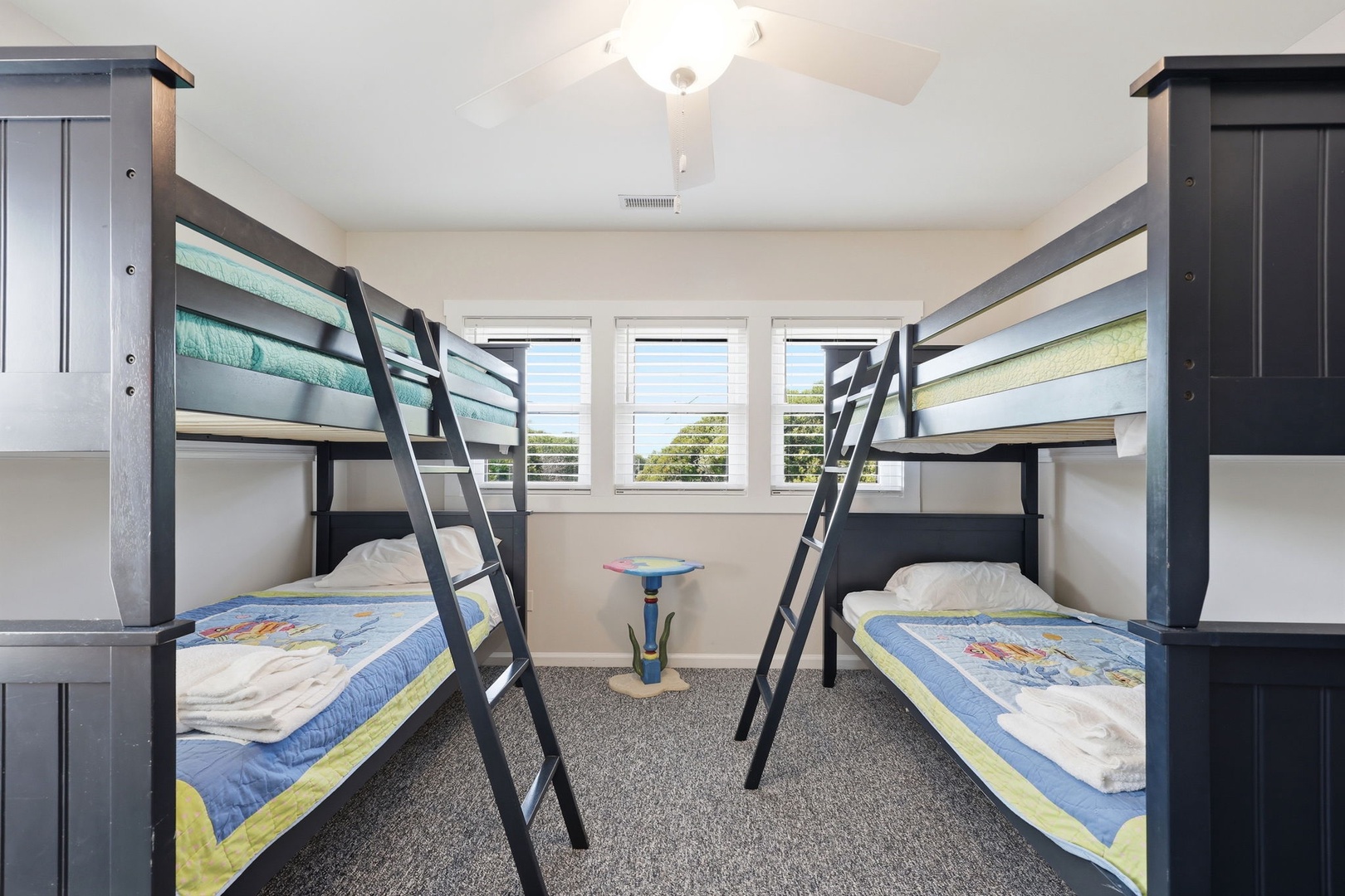 Two sturdy bunk beds make this room perfect for kids or groups. Bright windows and cheerful bedding create a welcoming space where everyone can settle in and feel at home.