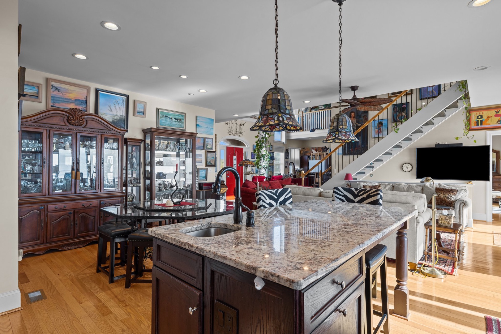 Your gourmet kitchen island becomes the heart of gathering, with granite counters and open design flowing to your cozy living space.