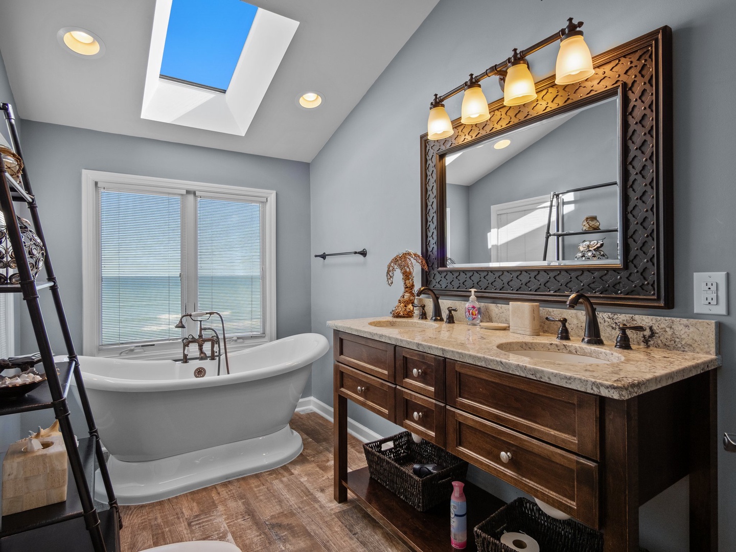 Soak away your stress in this spa-like bathroom with a luxurious freestanding tub and elegant double vanity.