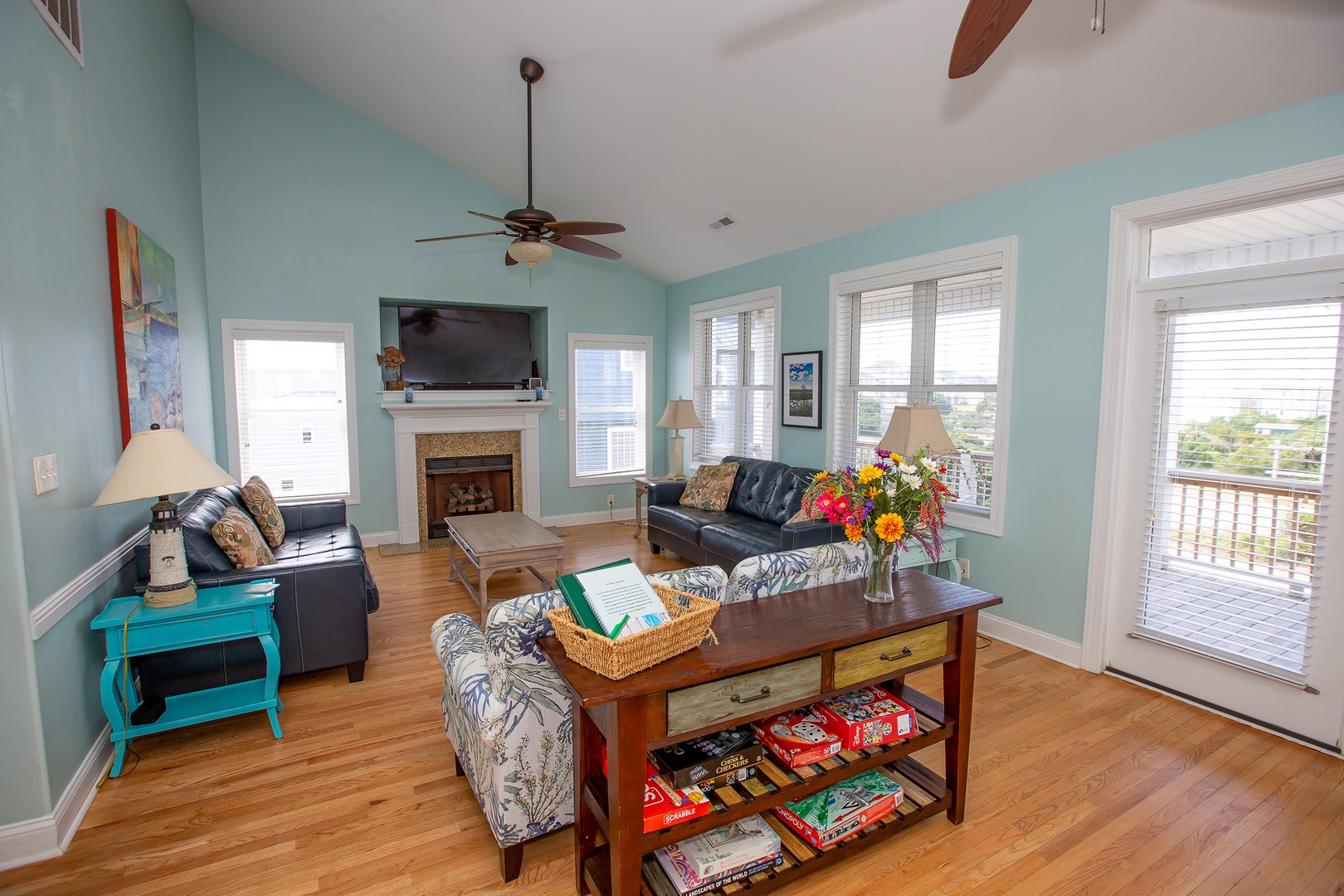 Unwind in this bright, coastal-inspired living room where soft blue walls and comfortable seating create your perfect retreat.