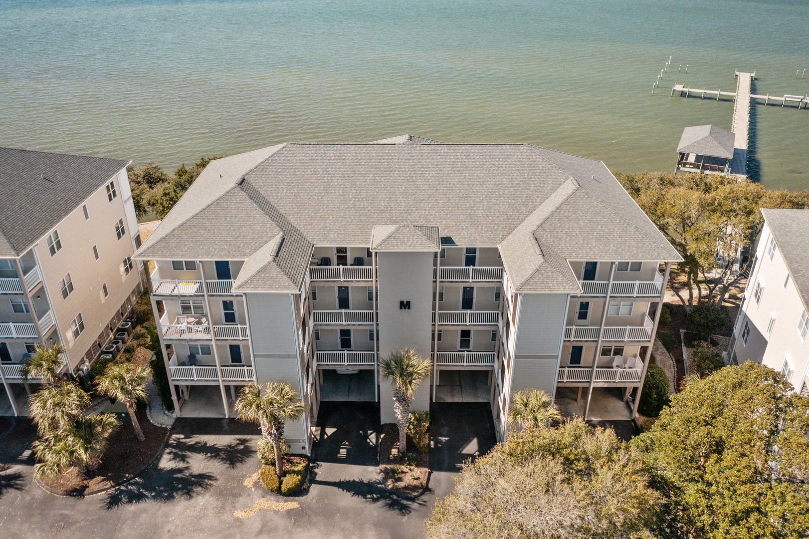 Waterfront vacation rental complex with private dock access and pristine water views in a peaceful coastal setting.