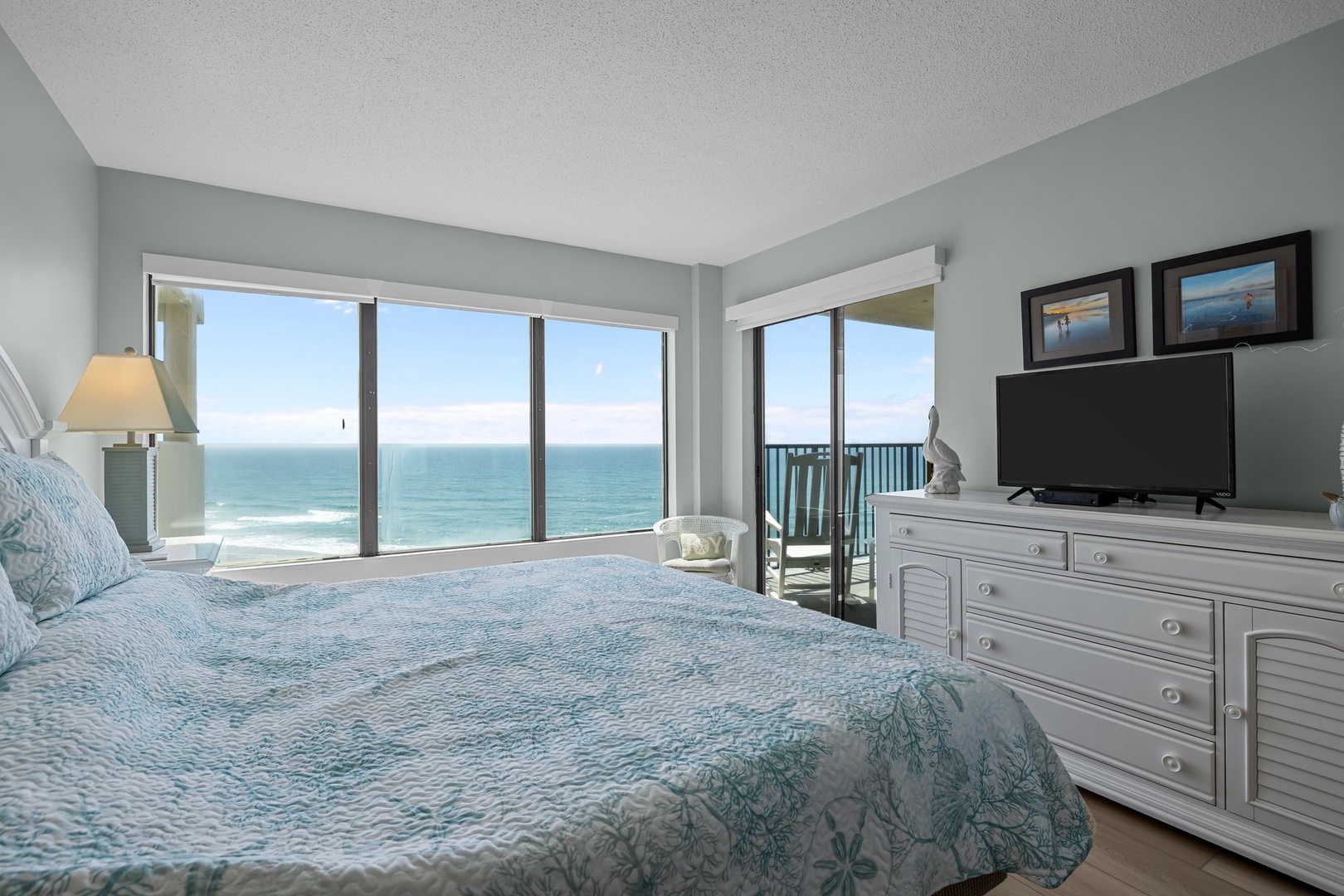 Wake to endless ocean views from your cozy bed. Floor-to-ceiling windows frame the sea while you enjoy morning coffee on your private balcony.