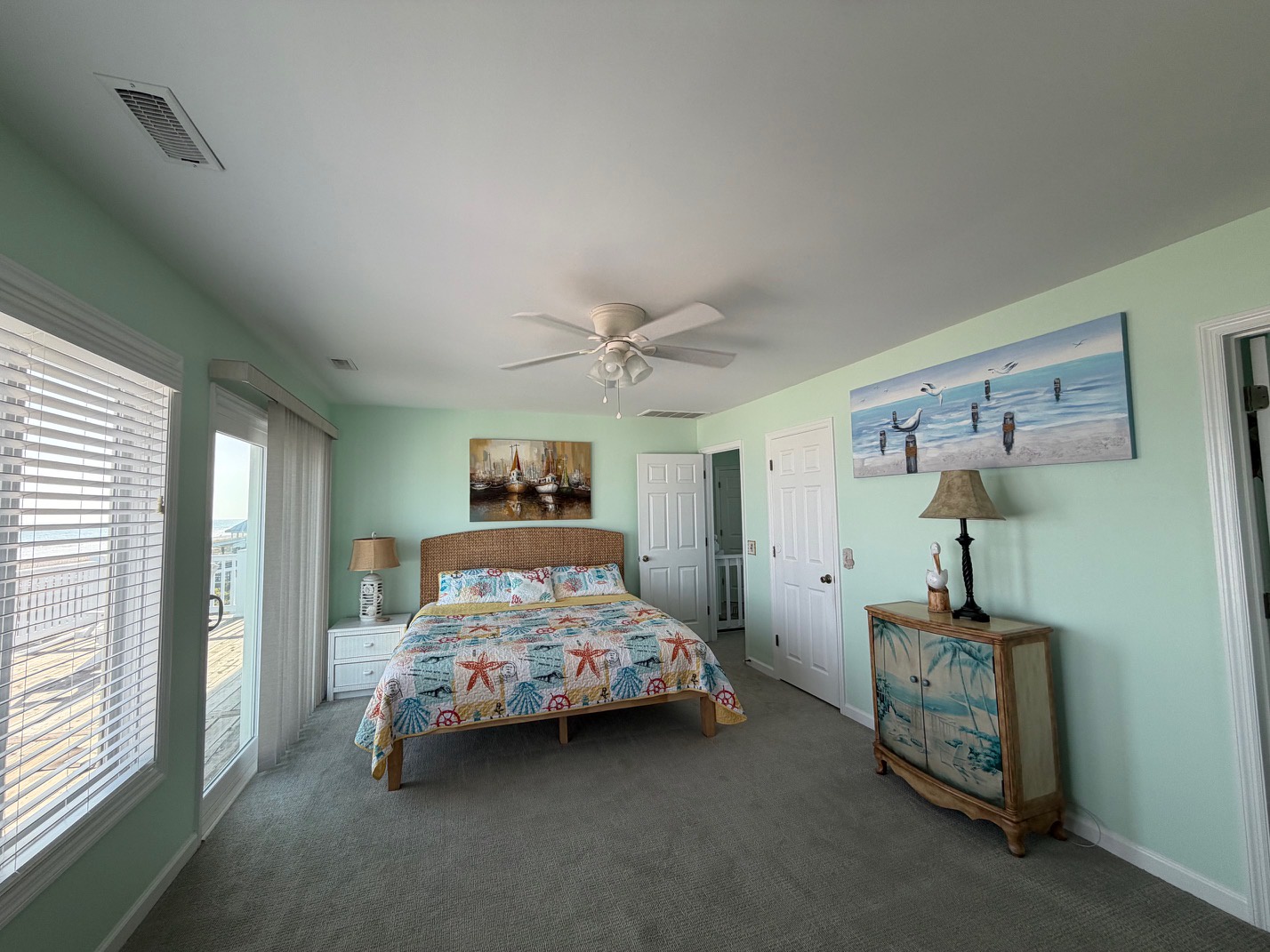 Wake up to coastal charm in your serene bedroom, where sea-themed decor and gentle mint walls create a peaceful retreat for restful nights.