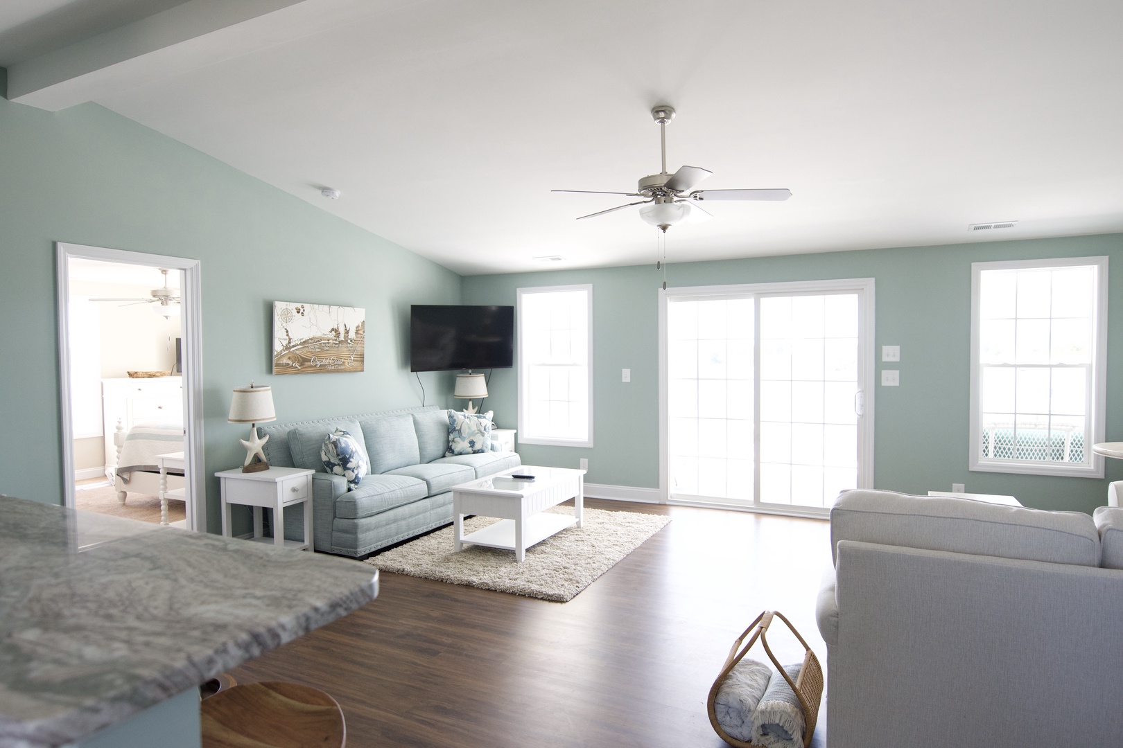 Unwind in your serene coastal living room with plush seating and soothing sea-glass walls that instantly melt away stress.