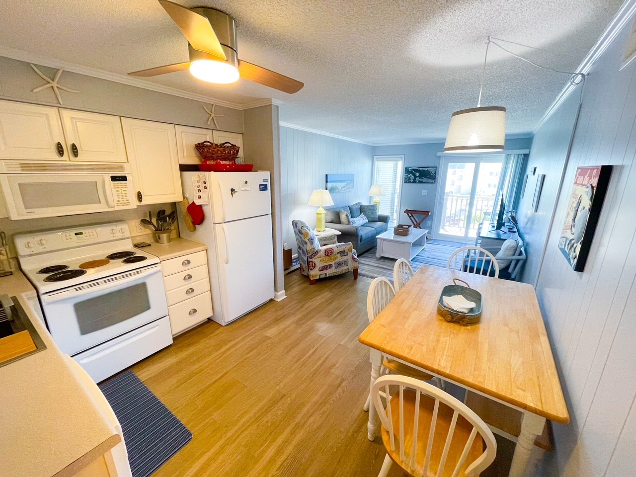 Your open-concept living space flows seamlessly from kitchen to dining to living room, perfect for gathering and relaxing together.