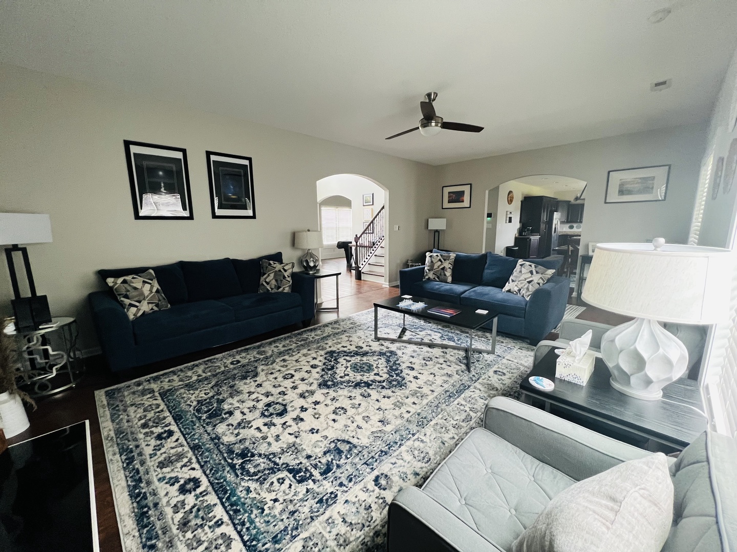 Sink into plush navy sofas in your spacious living room, where elegant decor and thoughtful touches create the perfect gathering space.