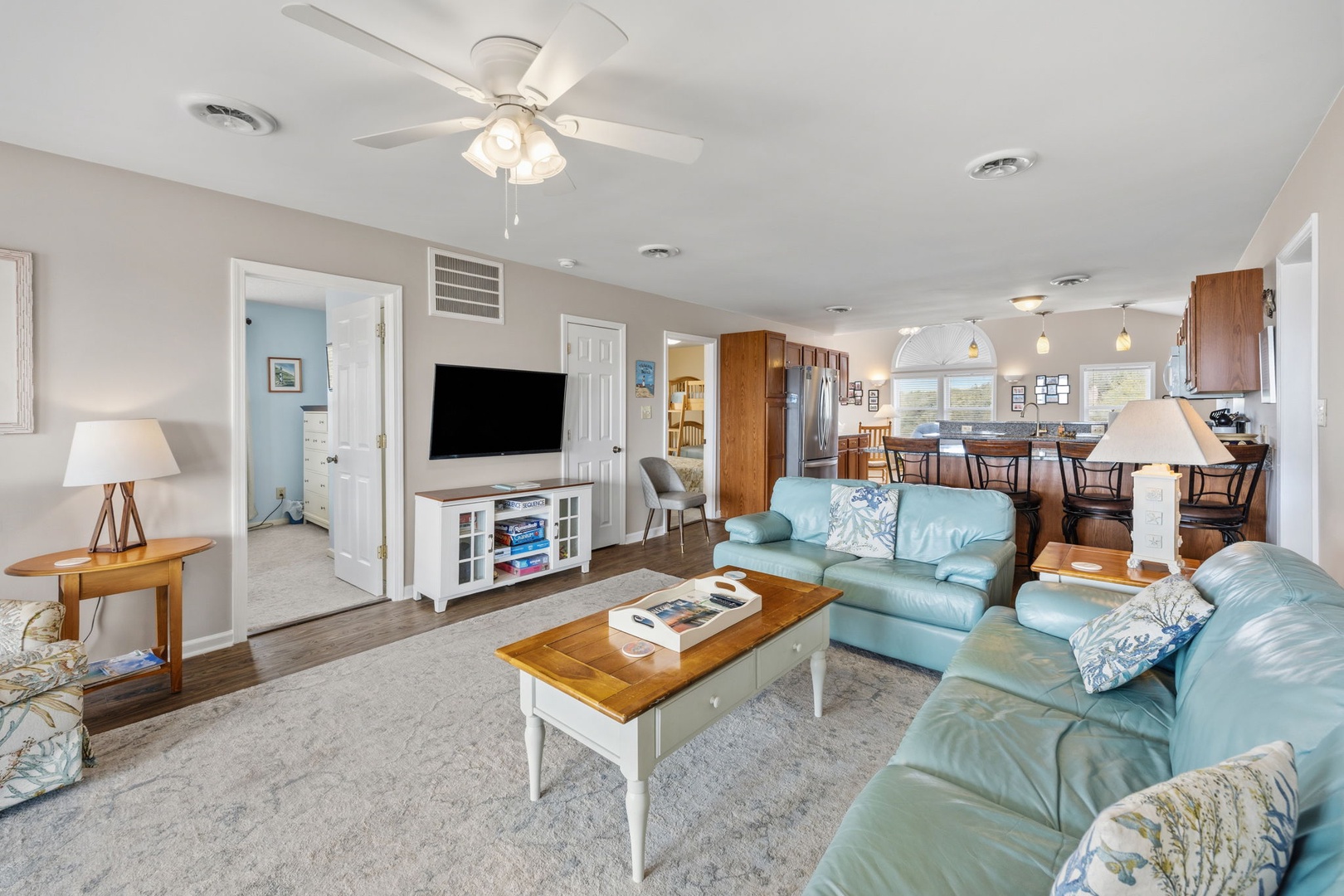Relax in your spacious living room with comfortable seating, entertainment center, and open flow to the fully-equipped kitchen.
