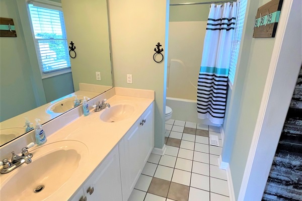 Your spacious bathroom features dual sinks and a relaxing tub-shower combo, perfect for refreshing after your adventures.