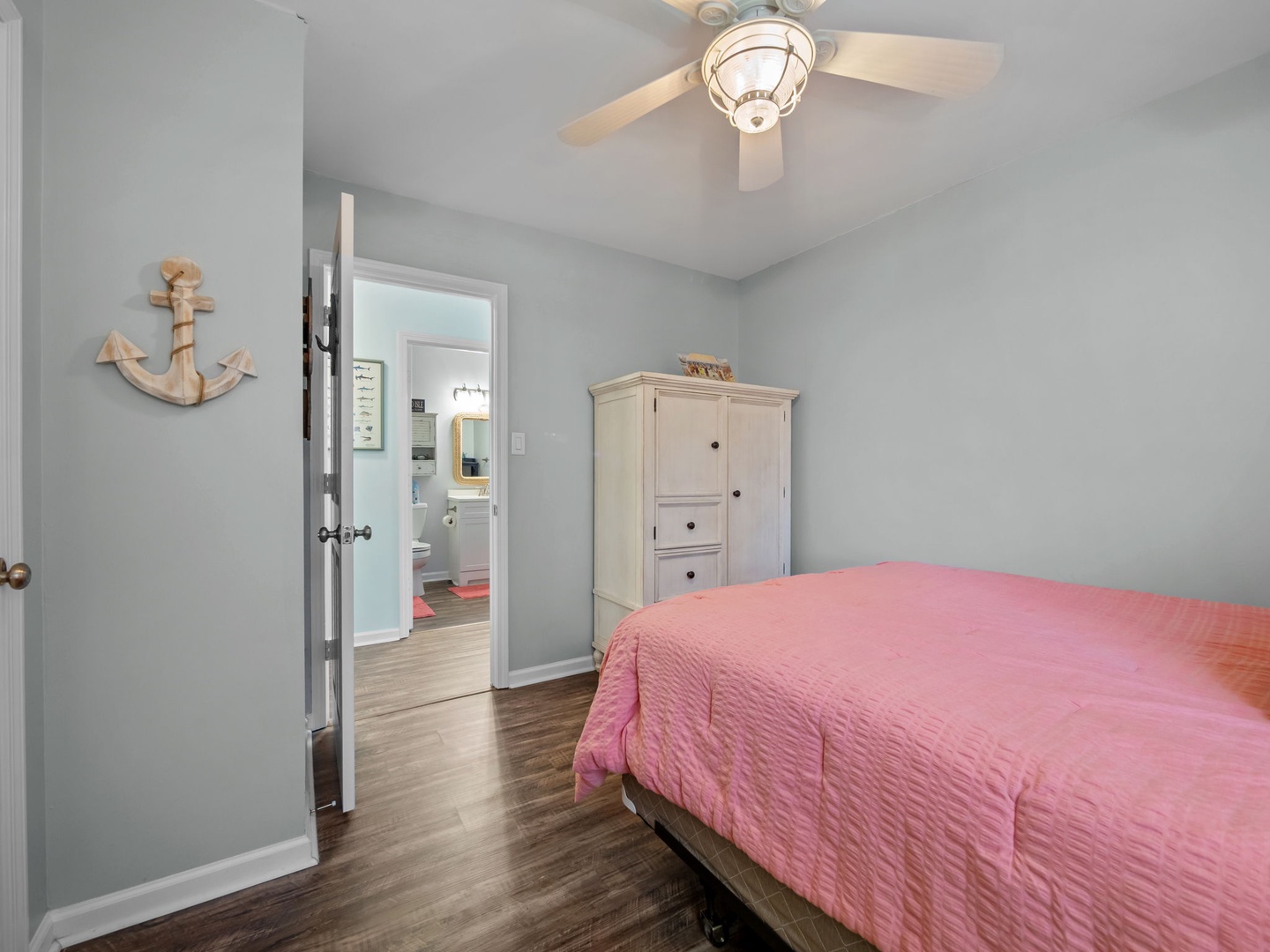 Drift off in your coastal-inspired bedroom, where soft sea breeze from the ceiling fan and nautical touches create perfect seaside serenity.