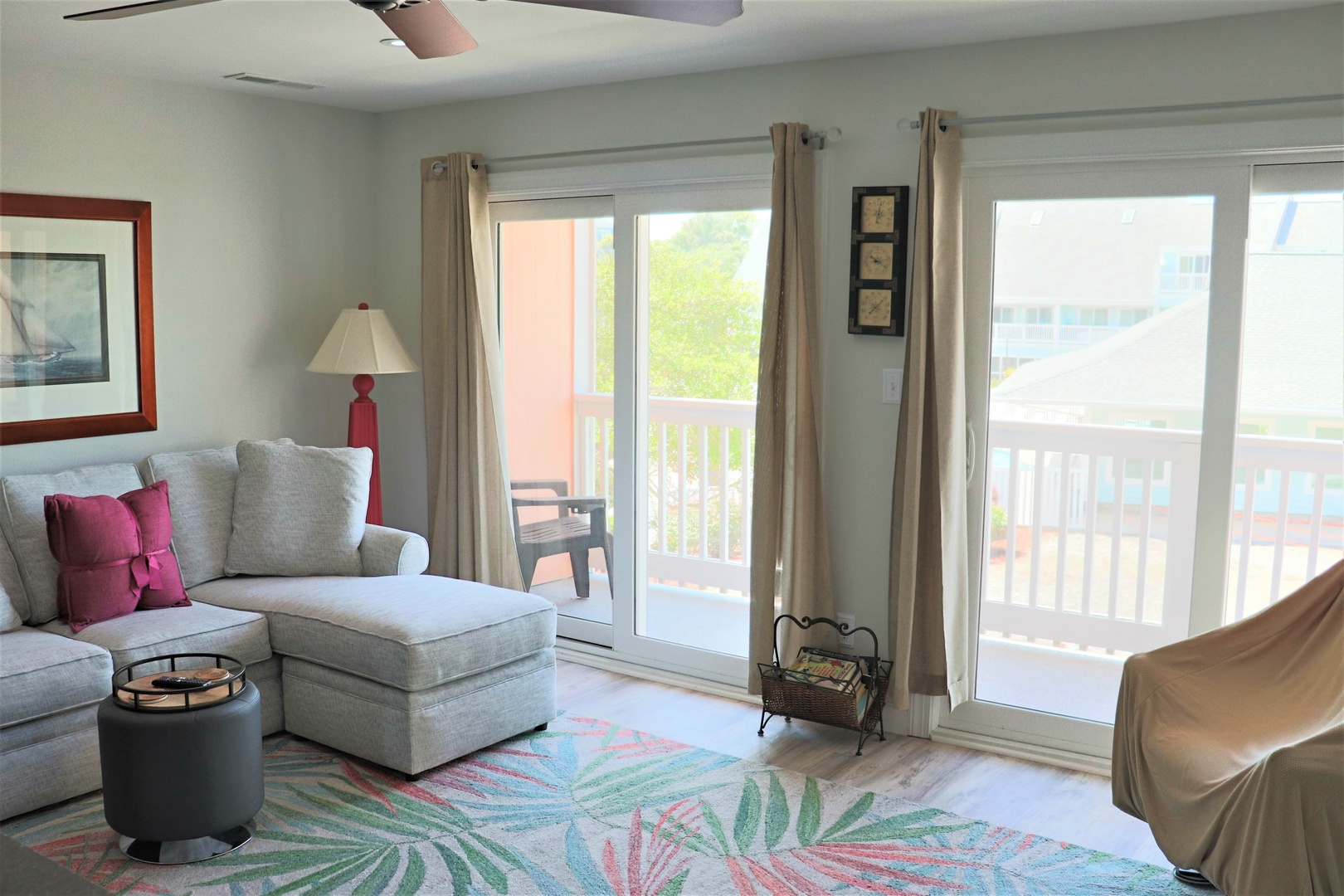 Settle into this bright, airy living room where your morning coffee tastes better by the sunny balcony doors.