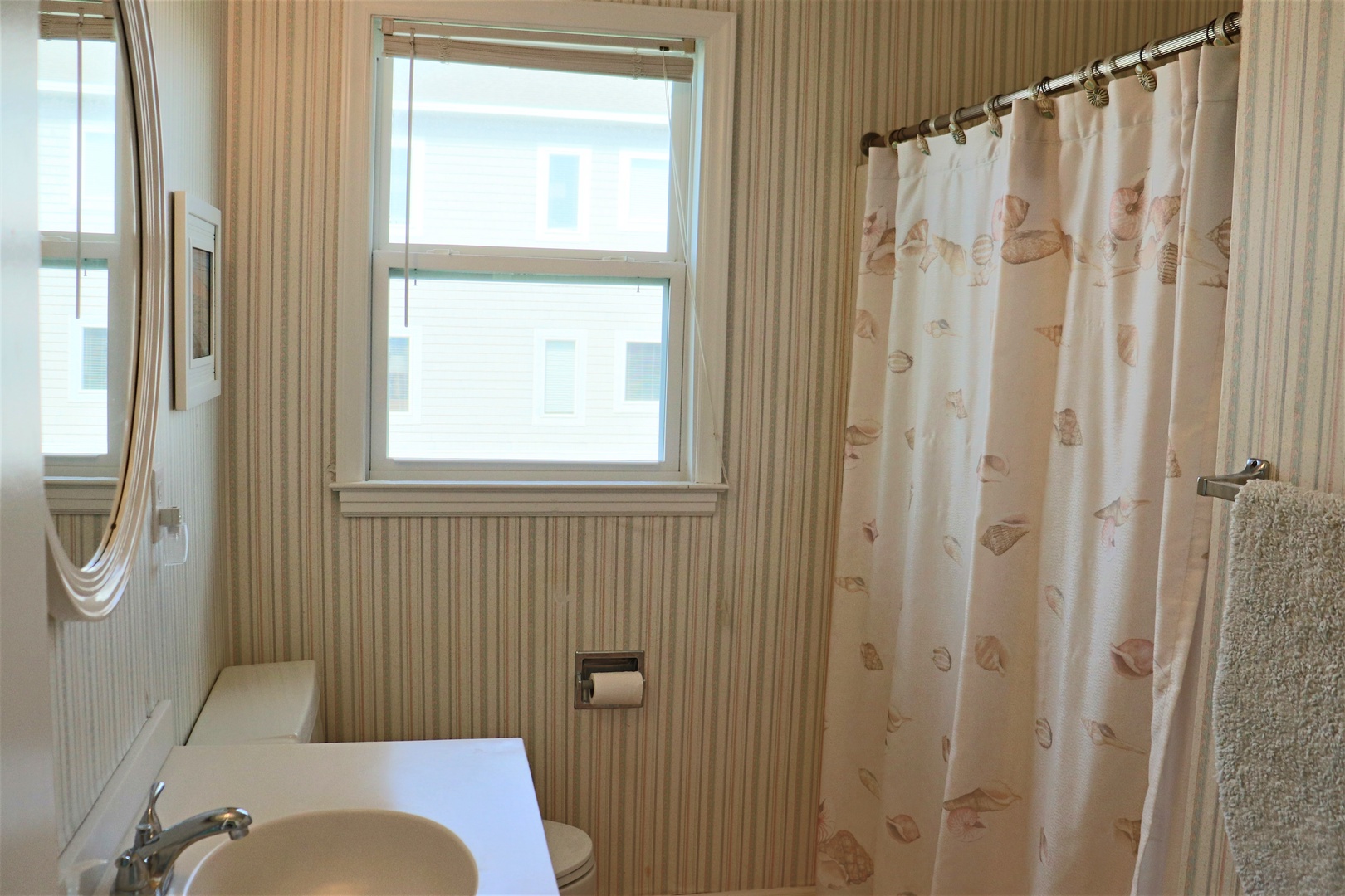 Refresh in your private bathroom with a full tub-shower combo and natural light streaming through the window.