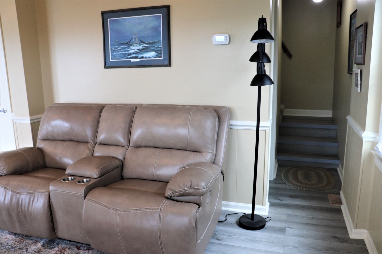 Relax in your comfortable leather loveseat while soft light from the modern floor lamp creates the perfect reading atmosphere.