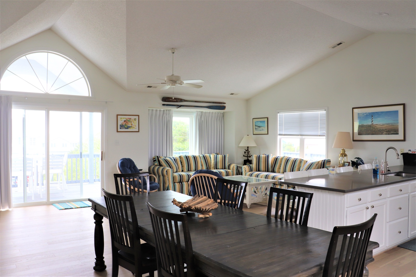 Your bright, airy living space flows seamlessly from kitchen to dining to lounge, with vaulted ceilings and ocean views creating the perfect coastal retreat.