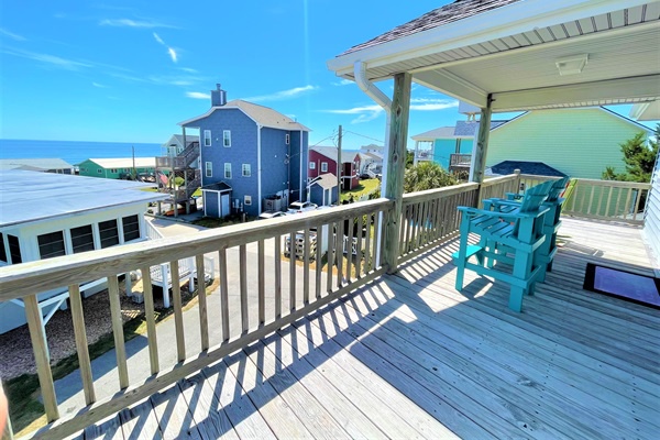 Soak up stunning coastal views from your private deck, where turquoise chairs invite you to unwind with ocean breezes and colorful beachside charm.