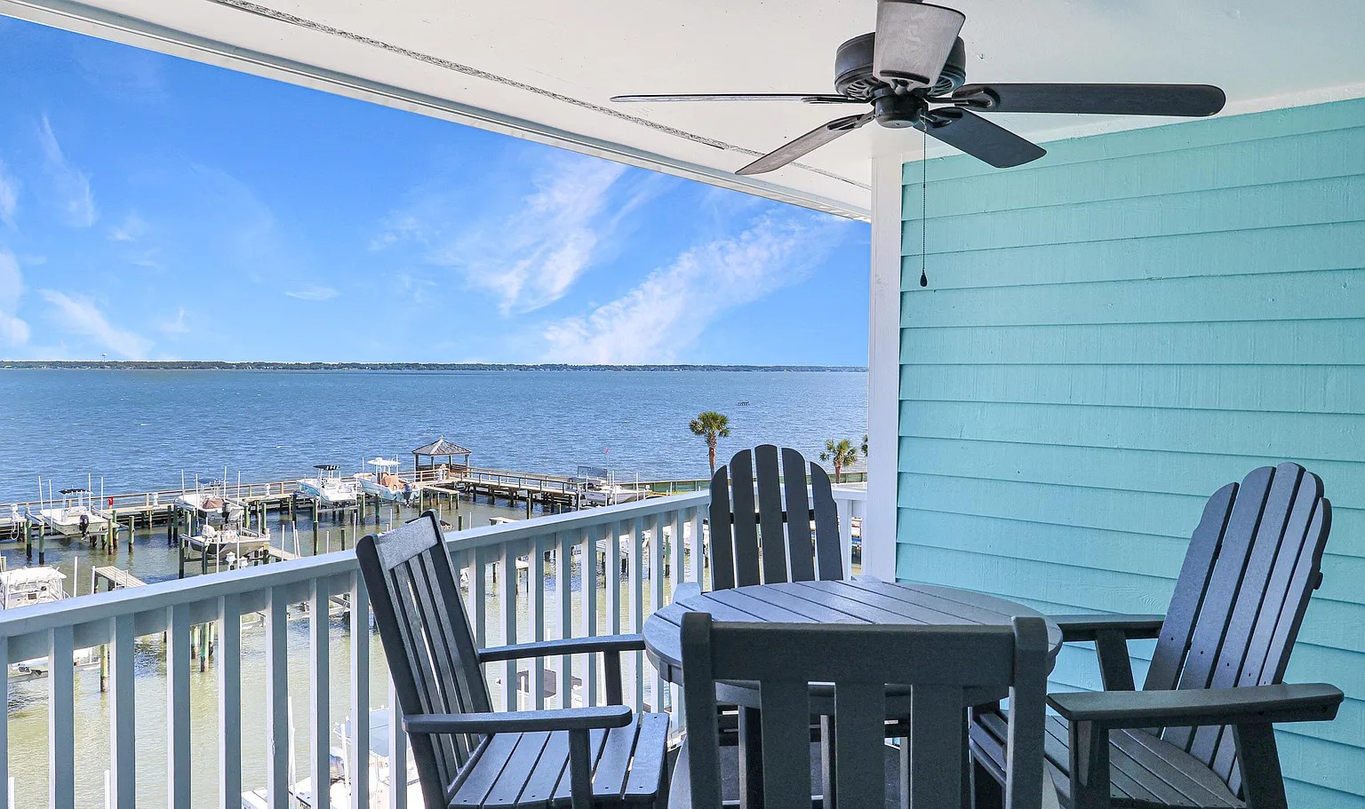 Your private waterfront balcony offers stunning bay views with comfortable seating and a cooling ceiling fan for perfect relaxation.