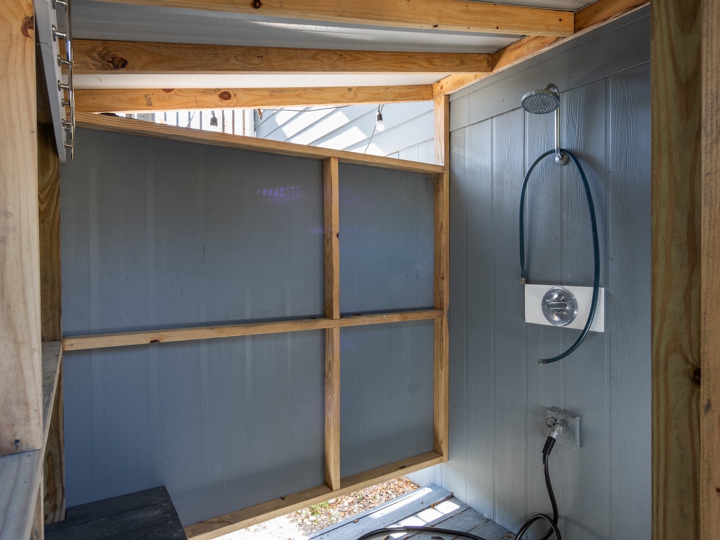 Step into your private outdoor shower sanctuary, where modern fixtures meet natural light through skylights for a refreshing escape.