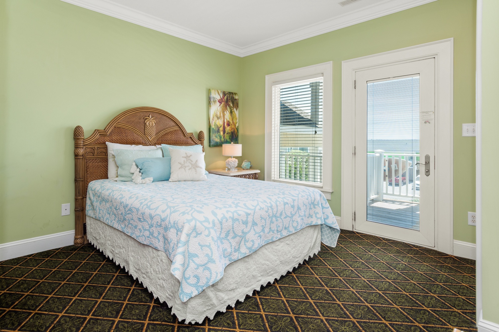 Wake up in your serene coastal bedroom where soft green walls and ocean-inspired linens create perfect tranquility. Step onto your private balcony for morning coffee.