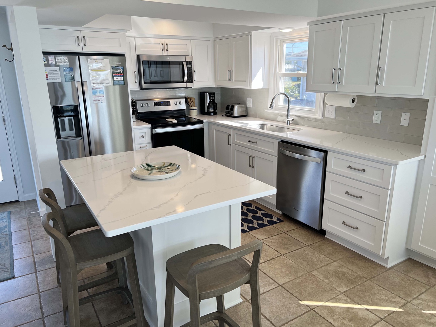 Your fully-equipped kitchen awaits with gleaming white cabinets, granite counters, and stainless appliances for effortless meal prep.