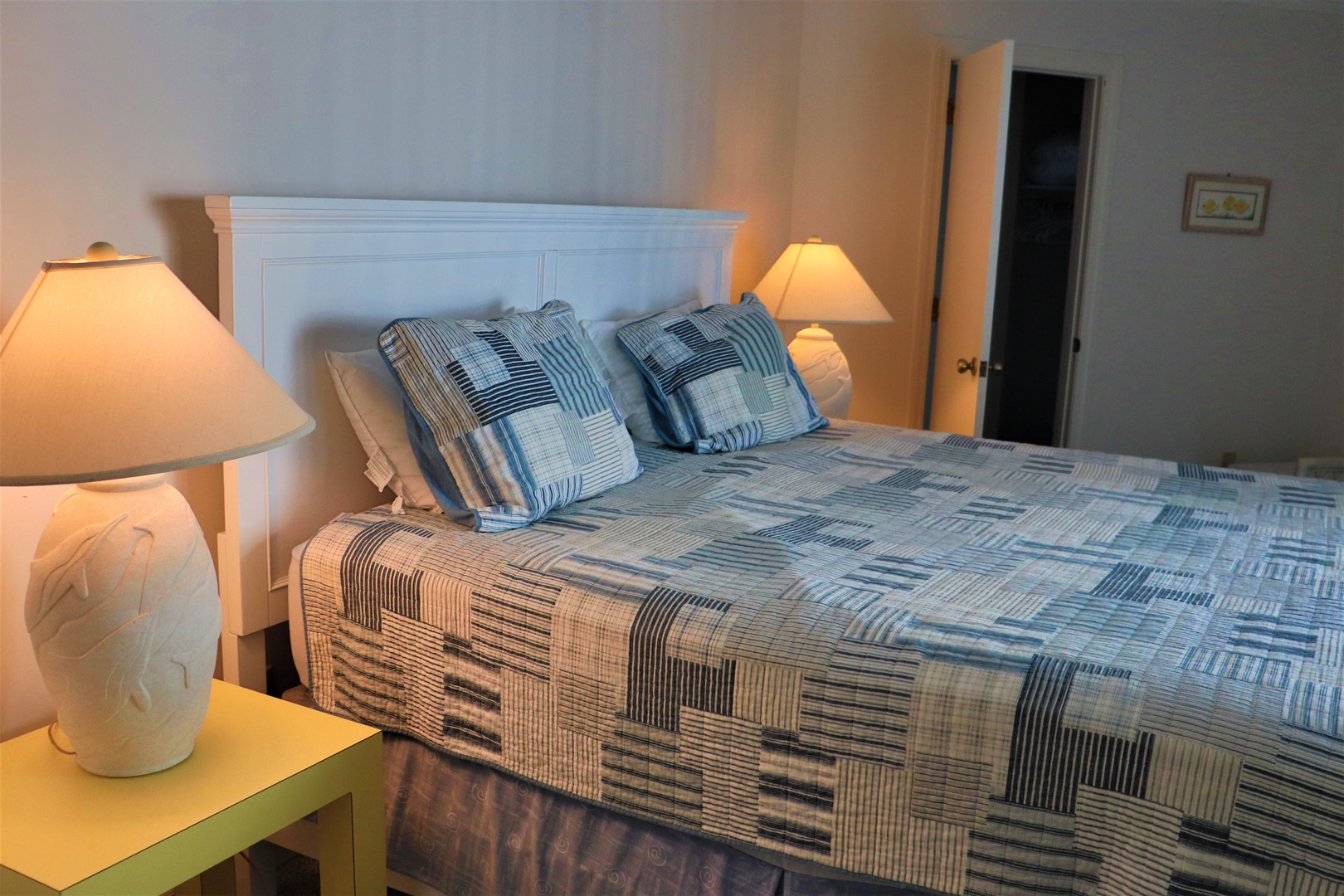 Settle into this cozy bedroom with soft lighting and comfortable linens for a peaceful night's rest.