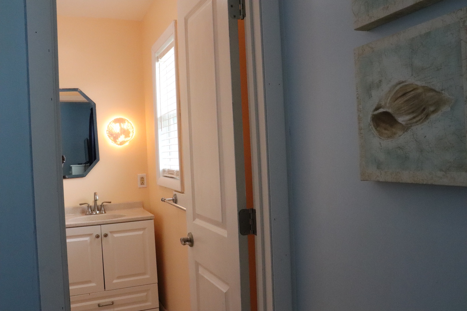 Step into your private bathroom with its crisp white vanity and warm lighting—a peaceful spot to refresh after a day of exploring.