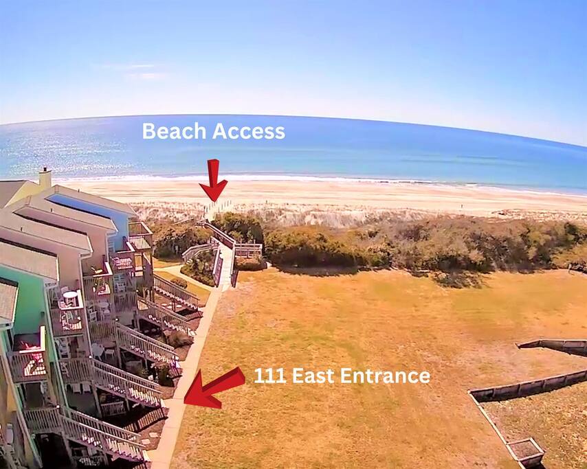 Aerial view showcasing direct beach access and property entrance, with pristine coastline stretching into the distance.