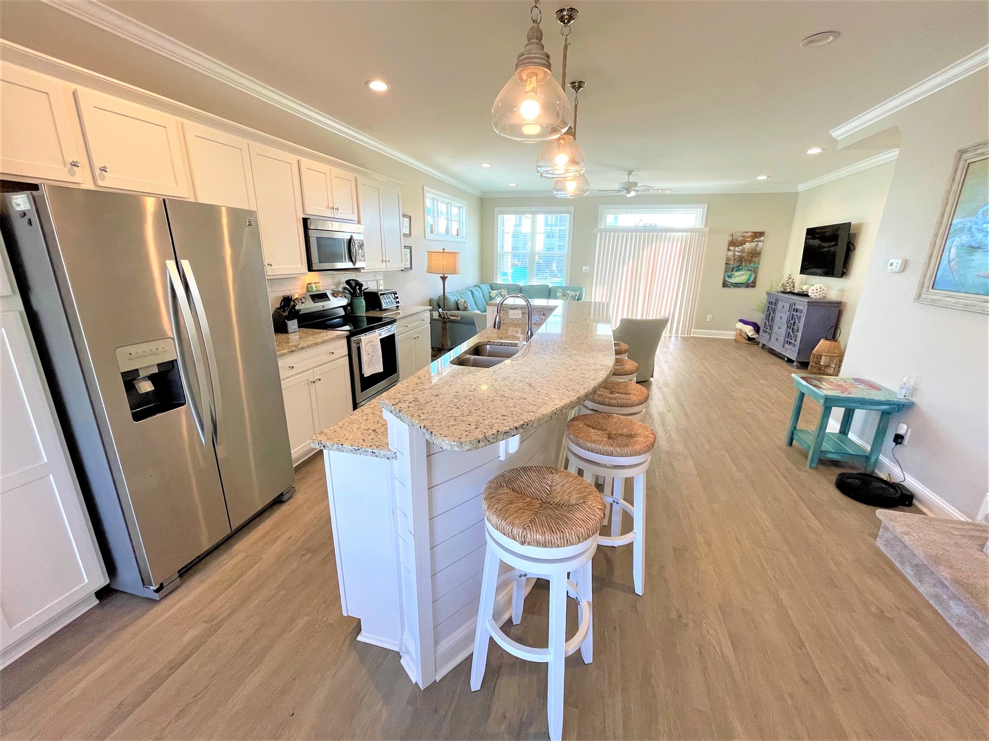 Your fully-equipped kitchen features granite countertops, stainless steel appliances, and a spacious island perfect for preparing meals and casual dining together.