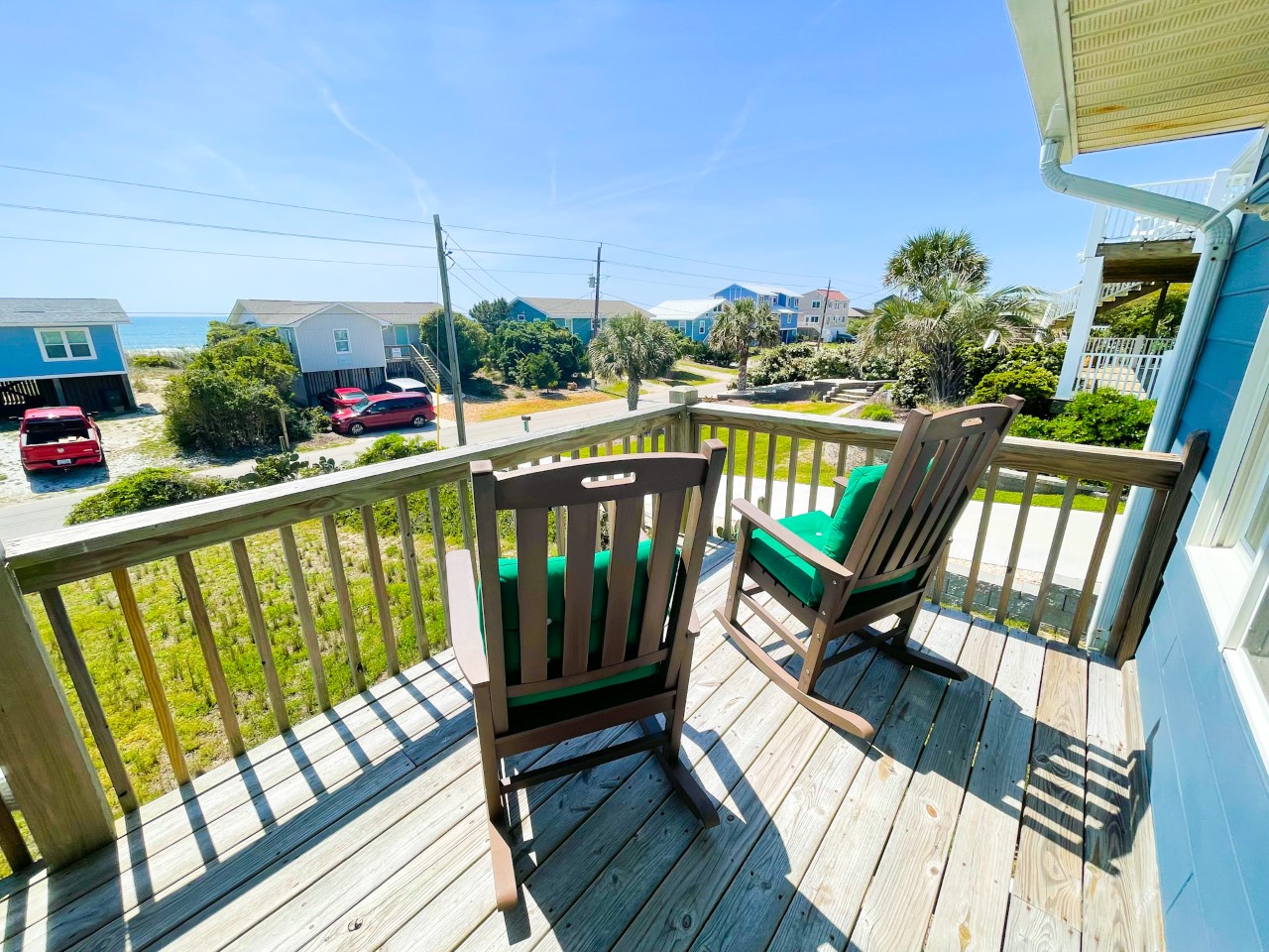 Relax in your private wooden rocking chairs while enjoying ocean breezes and views of the tropical neighborhood below.