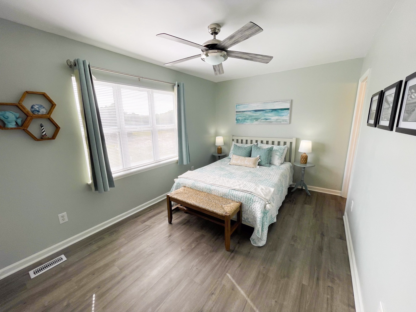 Your peaceful bedroom retreat awaits with calming coastal colors, comfortable queen bed, and gentle ceiling fan for perfect temperature control.