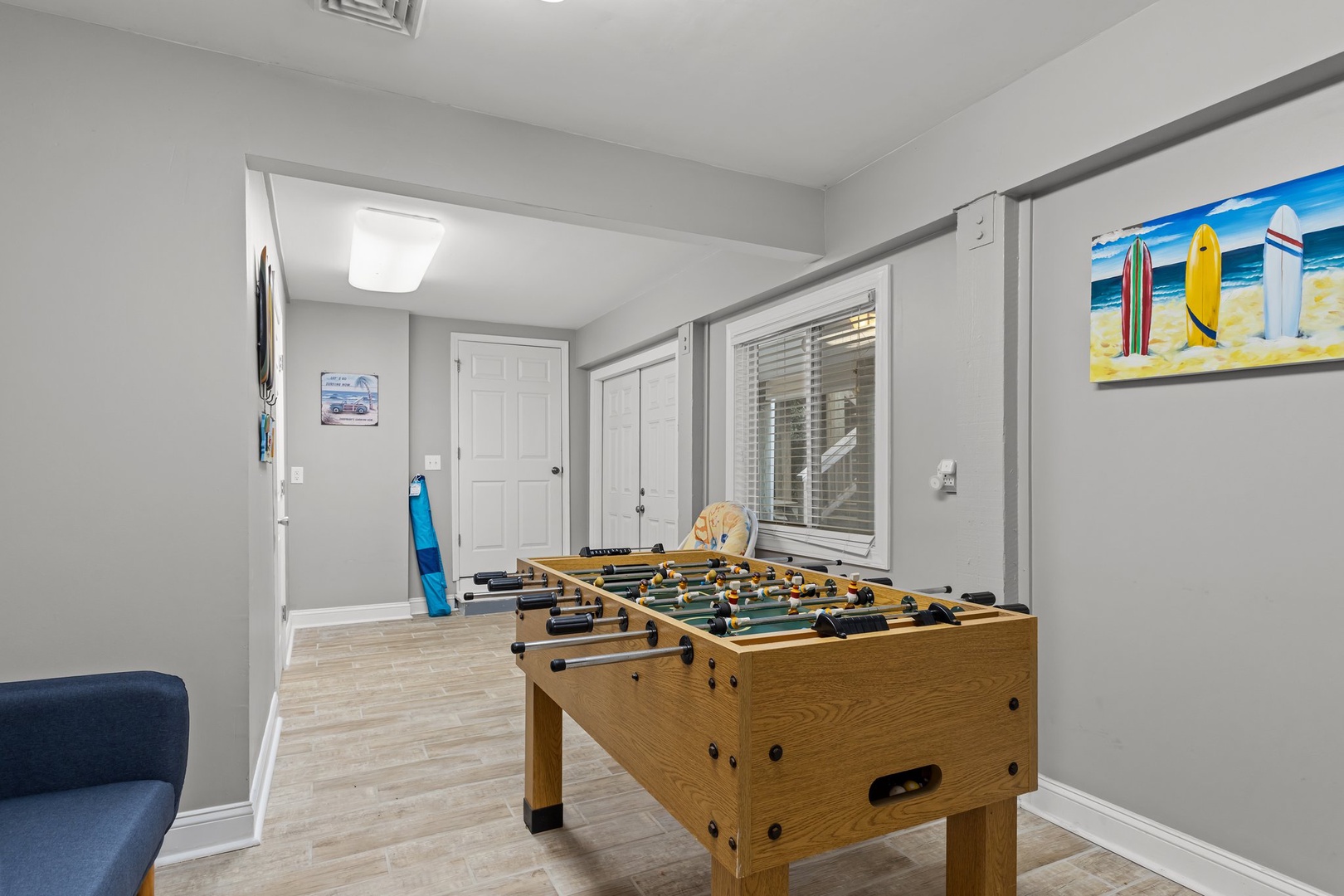 Challenge friends to foosball in your dedicated game room with beach-themed art.