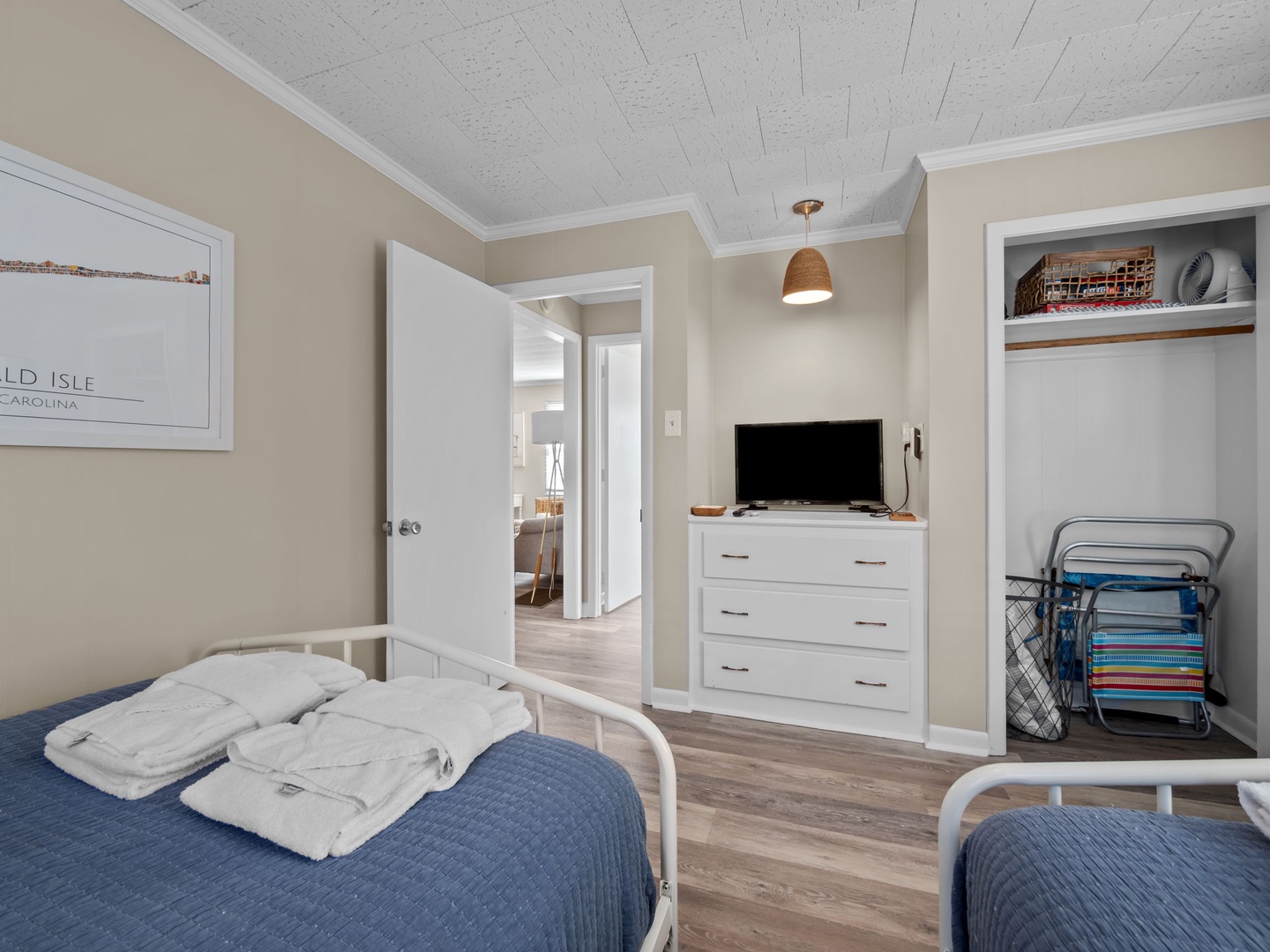 Sink into comfortable beds with crisp linens, enjoy your favorite shows on the flat-screen TV, and store belongings in the spacious closet.