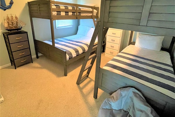 Sleep comfortably in your nautical-themed bedroom with sturdy bunk beds and crisp white linens awaiting your family's arrival.