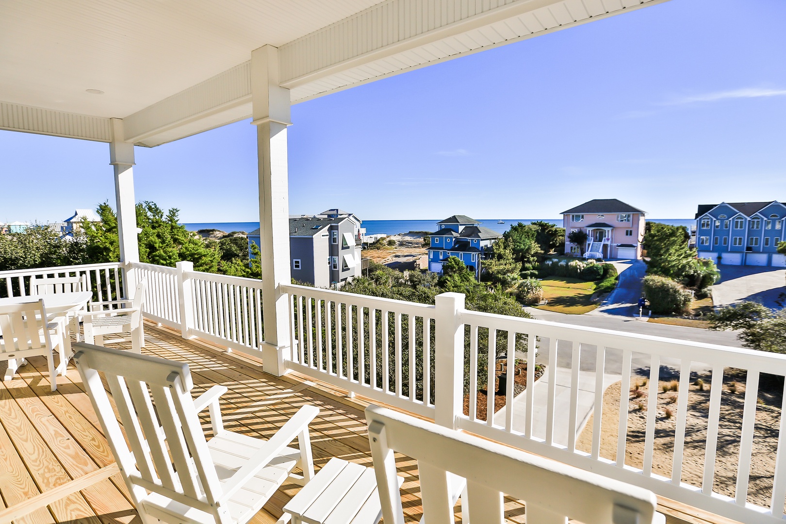 Relax on your private deck with stunning ocean views, watching waves from comfortable chairs in the coastal breeze.