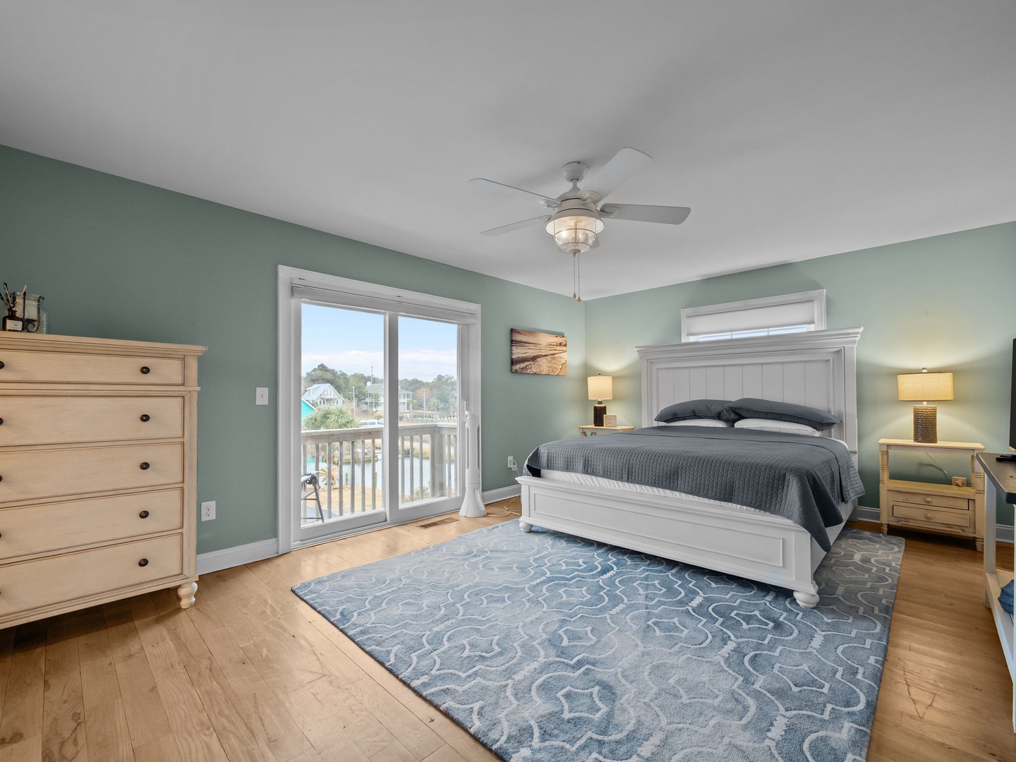 Rest peacefully in your serene bedroom where coastal colors meet comfort, complete with balcony access for morning coffee moments.